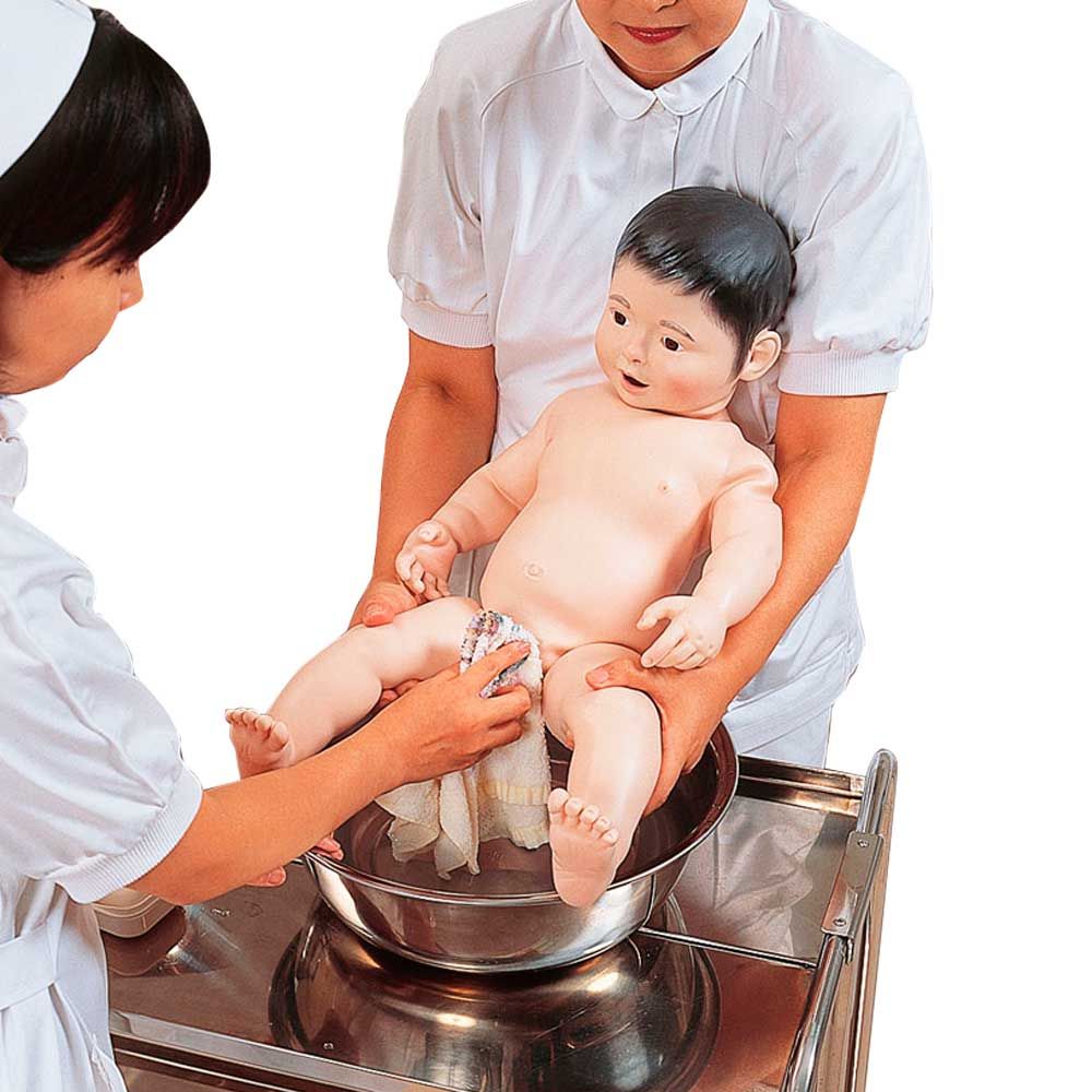 Weibliche Säuglings-Krankenpflegpuppe beim Baden in einer Metallschale